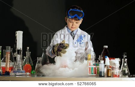 Image of cute boy experimenting in physics lab