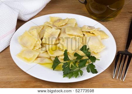 Italian pasta ravioli with parsley olive oil and flatware