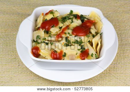 Italian pasta ravioli with parsley and tomato sauce