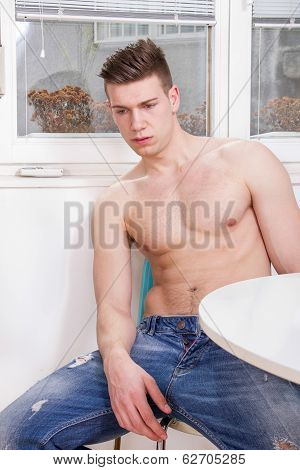 Sad Pensive Lonely Guy In Jeans With Naked Chest Sitting