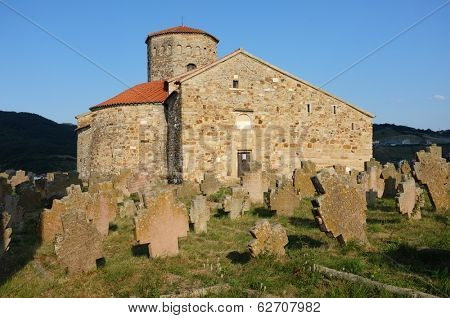 NOVI PAZAR, SERBIA - 26 July: historical cemetery and 9th century Serbian Orthodox Church of Holy Apostles St. Peter and St. Paul on July 26, 2013. UNESCO World Heritage Site since 1979