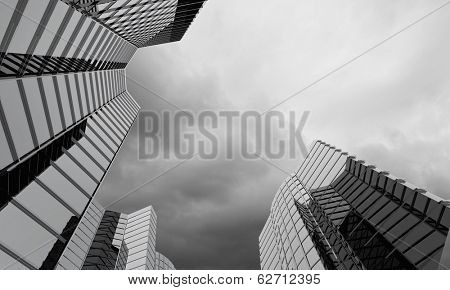 Bottom image of skyscraper with thunder lightning in sky