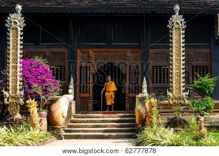 Old monk sitting on the doorsteps of a temple