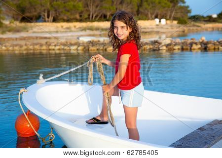 Kid girl pretending to be a sailor in boat bow at Formentera Balearic Islands