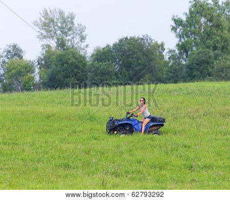 Elegant Woman Riding Extreme Quadrocycle