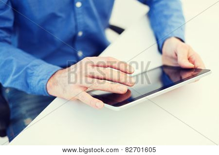 technology and internet concept - close up of male hands working with tablet pc computer