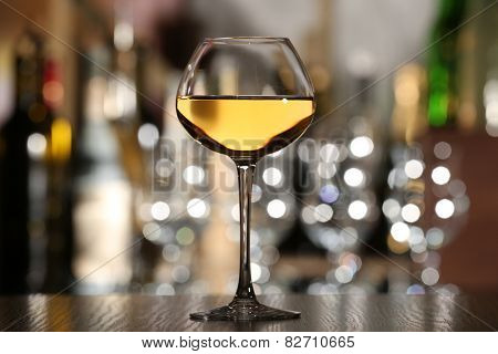 Glass of wine with bar on background