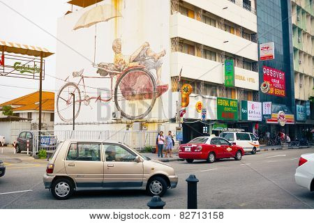 Malaysia, Penang, Georgetown - Circa Jul 2014: Traffic Passes On A Public Street With A Large Mural