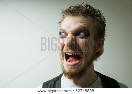 portrait of evil, aggressive man with makeup