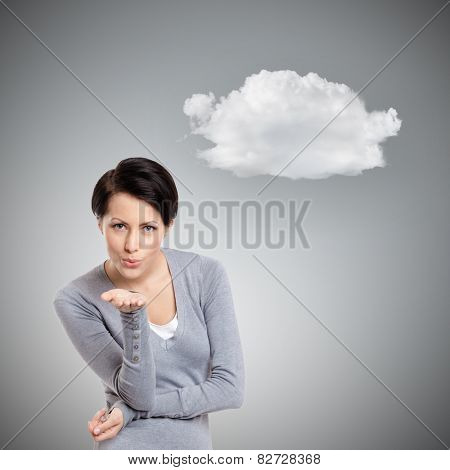 Beautiful lady throws a kiss, isolated on grey background with cloud