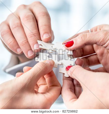 Human Hands Assembling Puzzle Pieces
