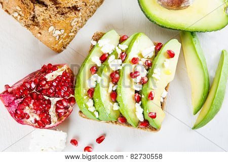 Avocado With Feta, Pomegranate On Sunflower Seeds Bread Sandwich.
