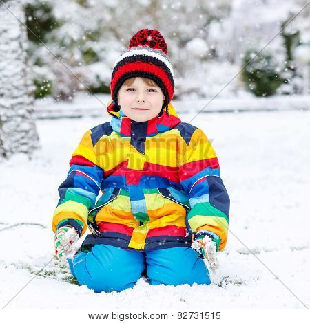 Funny Preschool Boy In Colorful Clothes Happy About Snow, Outdoors