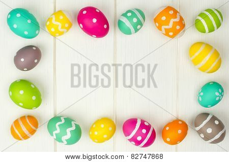 Easter egg frame against white wood