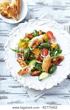 Chicken salad with naan bread and olives