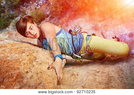 Rock climber climbing up a cliff