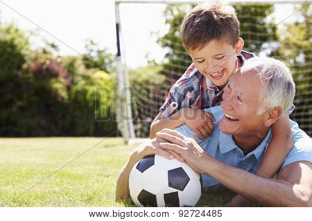 Portrait Of Grandfather And Grandson With Football