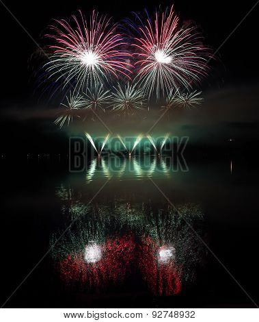 Colorful Fireworks With Reflection On Lake.