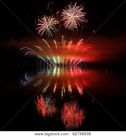 Colorful Fireworks With Reflection On Lake.
