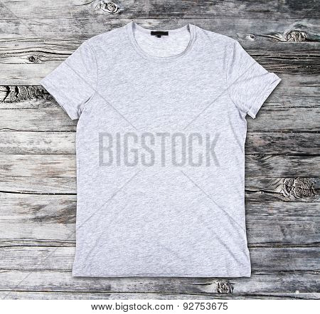 Blank Gray T-shirt On A Wooden Surface