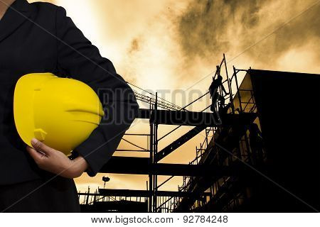 Engineer Holding Yellow Helmet