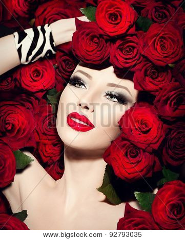 Beauty Sexy Fashion Model Girl. High Fashion Vogue style model portrait with red roses flowers hairstyle. Art glamour Woman with bright red make-up and accessories. Holiday makeup