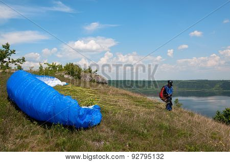 Paraglider Prepares To Fly Over Beautiful Bakota Reservoir.