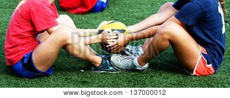 Two athletes doing an abdominal workout on the turf