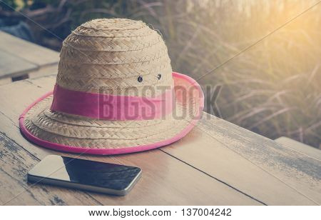 Farmer Hat with smart phone for Modern hi technology farmer on table vintage tone.