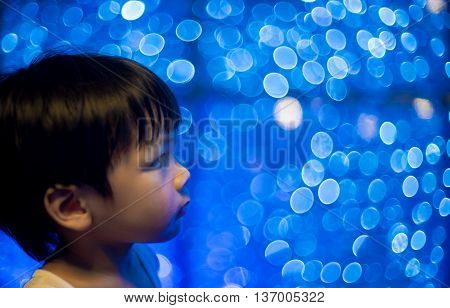 Asian boy with disco bokeh light background