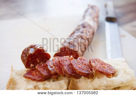 white pizza or bread focaccia stuffed with slices of salami