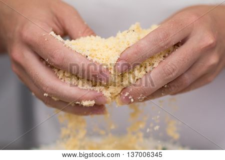 Homemade baking kitchen scene showing Butter Flour Sugar and Vanilla Seeds being mixed to make shortbread biscuits with womans hands.