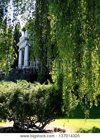 The old courthouse framed by willows is an example of the rich history in Prineville, Oregon.