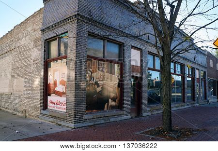 JOLIET, ILLINOIS / UNITED STATES - NOVEMBER 1, 2015: A vacant brick building formerly housed a furniture store in downtown Joliet.