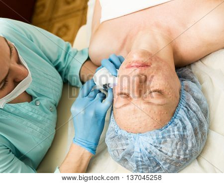 Beautician makes biorevitalization to young woman. The cosmetic procedures for the face. Beauty treatments in the spa salon. Facial Skin Care.