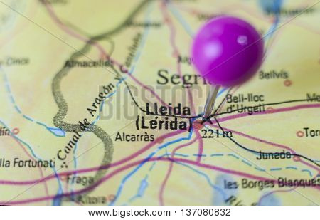 Pushpin marking on Lleida Spain. Selective focus on city