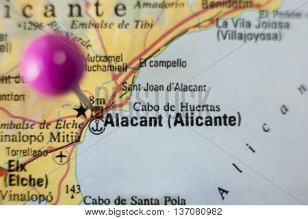 Pushpin marking on Alicante Spain. Selective focus on city