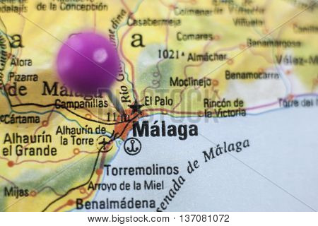 Pushpin marking on Malaga Spain. Selective focus on city