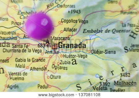 Pushpin marking on Granada Spain. Selective focus on city