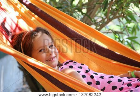 Smiling Pretty Baby Rests In A Hammock