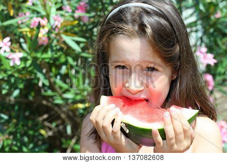 Cute Little Girl With Long Brown Hair Eating Watermelon