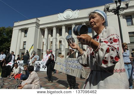 Kiev Ukraine - July 5 2016: Public activists rattling the cups of prison to parliament voted for arrest an escaped politician Alexander Onishchenko in Russia near the building of the Verkhovna Rada of Ukraine