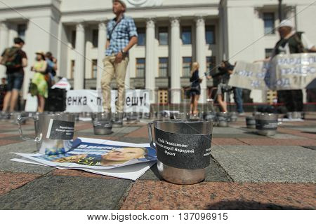 Kiev Ukraine - July 5 2016: Public activists rattling the cups of prison to parliament voted for arrest an escaped politician Alexander Onishchenko in Russia near the building of the Verkhovna Rada of Ukraine