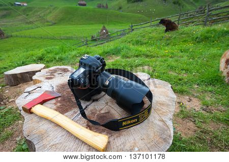BRASOV, ROMANIA - MAY 24, 2016: NIKON D5 DSLR  left on a log
