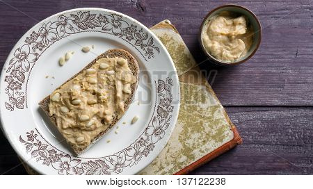 Hummus toast on old recipe book. Traditional middle east meal. Top view