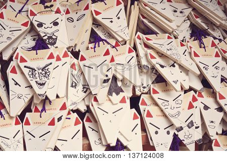 KYOTO, JAPAN - APRIL 29, 2016 : Ema prayer tablets with unique fox-shaped boards at Fushimi Inari Taisha Temple in Kyoto. Pray for luck, wealth, happiness, health, fortune, protection.