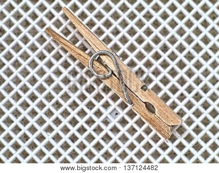 Old wooden clothespin on a white basket