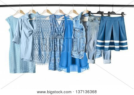 Set of blue clothes on clothes racks isolated over white