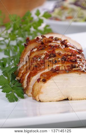 Baked chicken breast with spice sliced on a plate