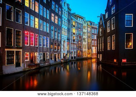 Houses over canal with reflections at night, Amstardam, Netherlands, toned